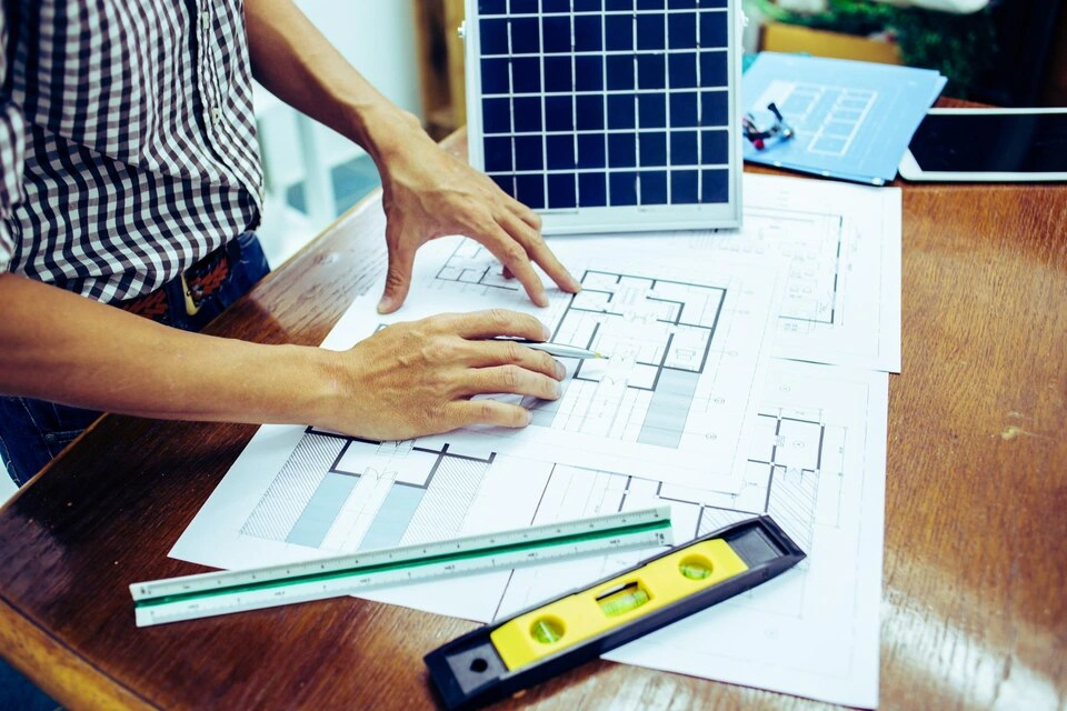 Solar technician conducting a site survey on a rooftop